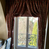 Italian strung curtains with Roman blind behind